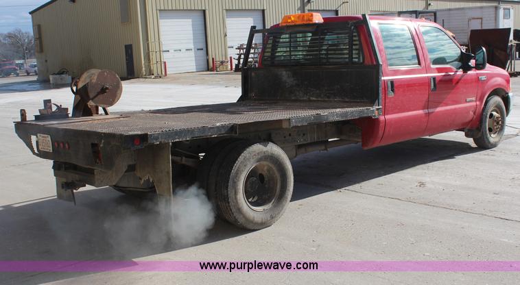 image for item H7876 2004 Ford F350 Crew Cab flatbed pickup truck