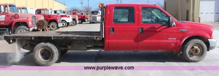 image for item H7876 2004 Ford F350 Crew Cab flatbed pickup truck