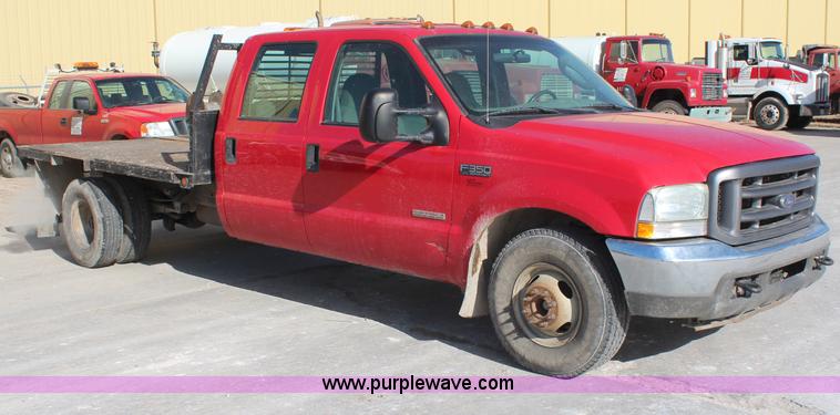 image for item H7876 2004 Ford F350 Crew Cab flatbed pickup truck