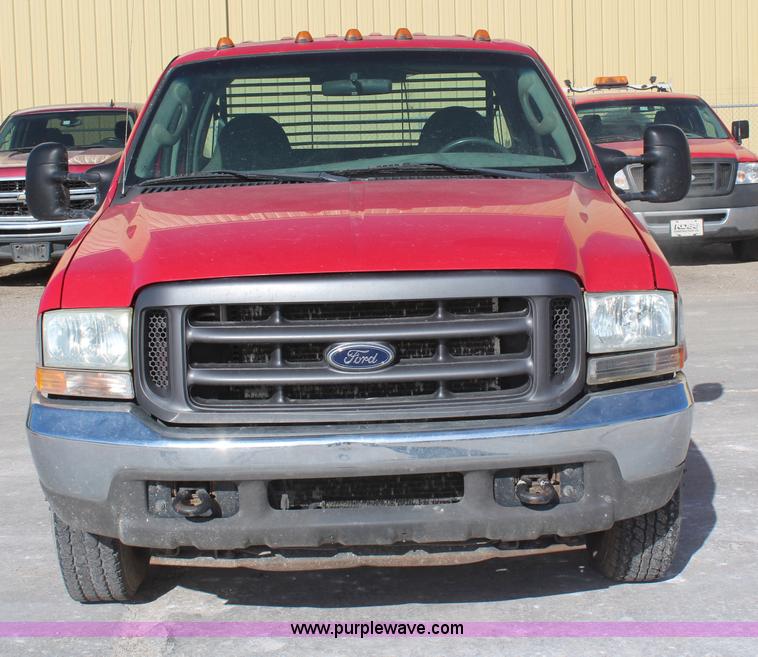 image for item H7876 2004 Ford F350 Crew Cab flatbed pickup truck