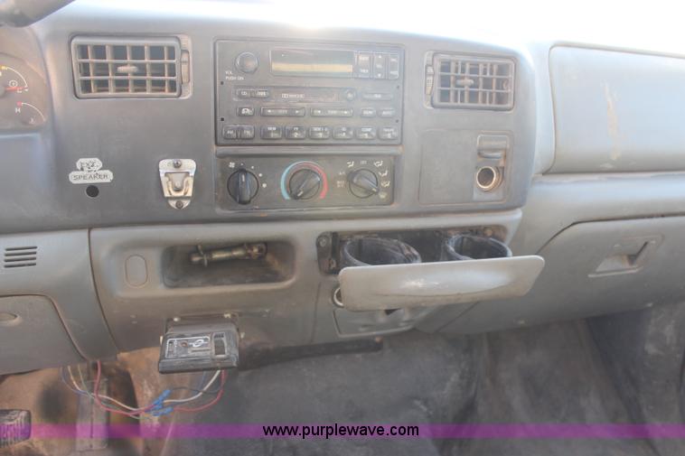 image for item H7876 2004 Ford F350 Crew Cab flatbed pickup truck