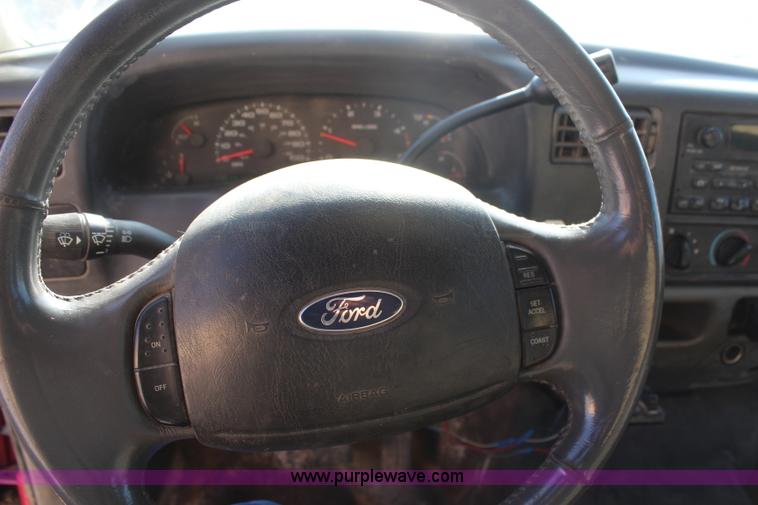 image for item H7876 2004 Ford F350 Crew Cab flatbed pickup truck