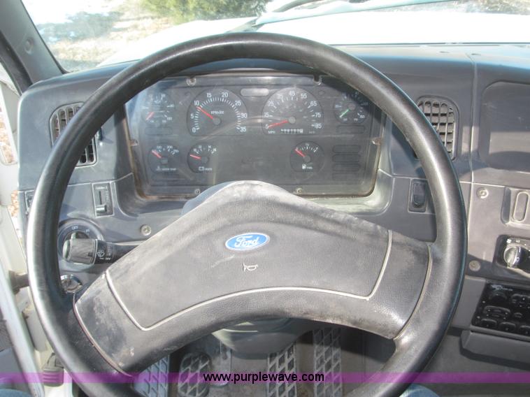 image for item F7252 1997 Ford L8501 Louisville 20' flatbed truck with lift gate