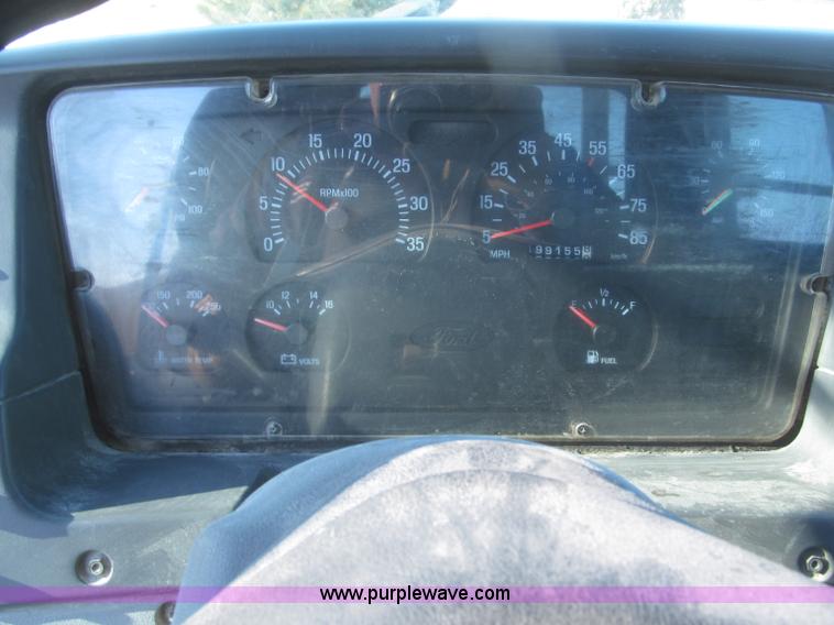 image for item F7252 1997 Ford L8501 Louisville 20' flatbed truck with lift gate