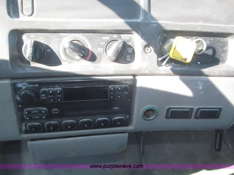 image for item F7252 1997 Ford L8501 Louisville 20' flatbed truck with lift gate