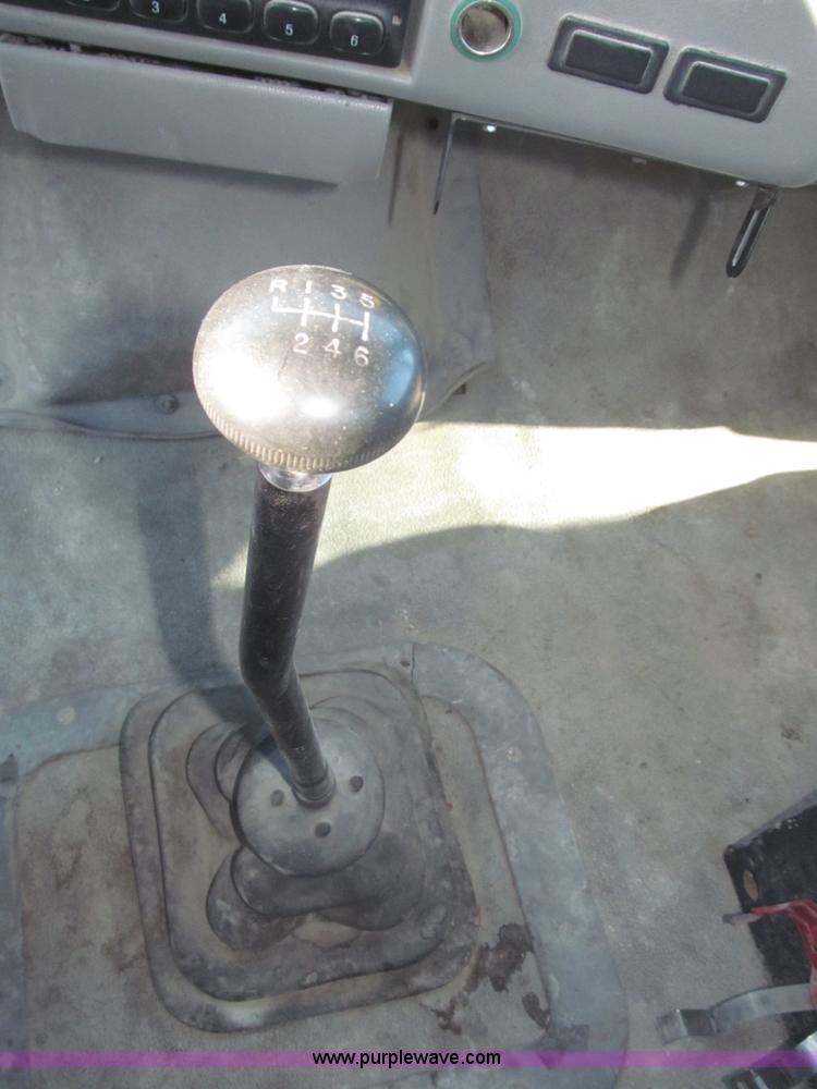 image for item F7252 1997 Ford L8501 Louisville 20' flatbed truck with lift gate