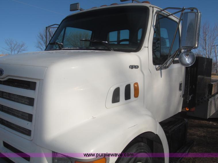 image for item F7252 1997 Ford L8501 Louisville 20' flatbed truck with lift gate