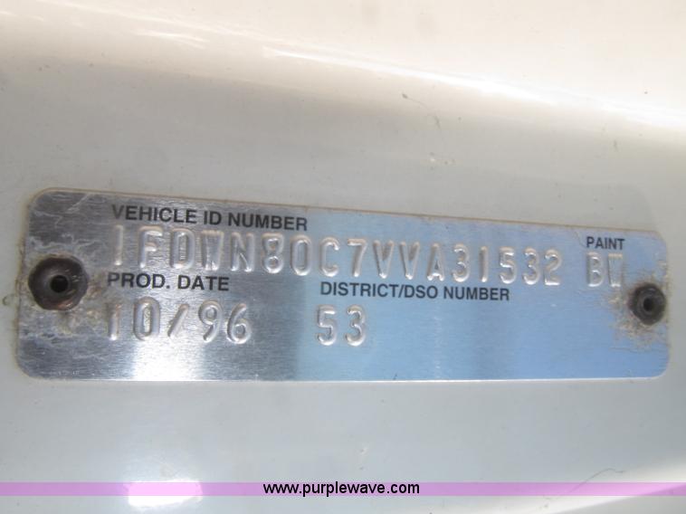 image for item F7252 1997 Ford L8501 Louisville 20' flatbed truck with lift gate