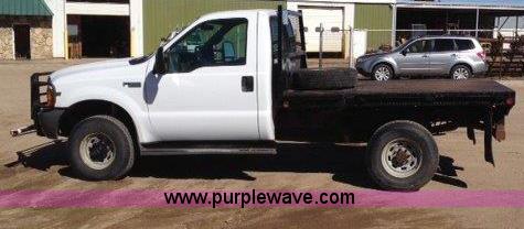 image for item C1853 1999 Ford F350 flatbed pickup truck