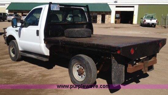 image for item C1853 1999 Ford F350 flatbed pickup truck