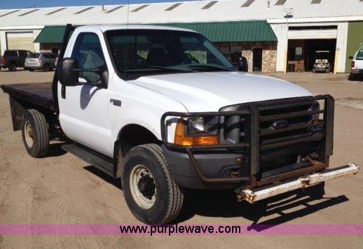 image for item C1853 1999 Ford F350 flatbed pickup truck