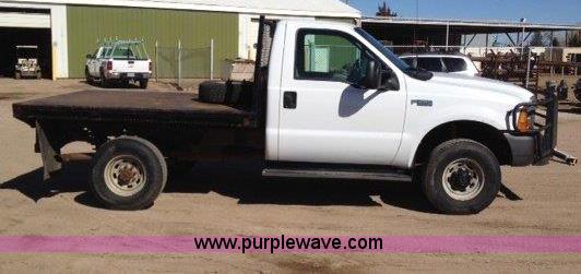 image for item C1853 1999 Ford F350 flatbed pickup truck