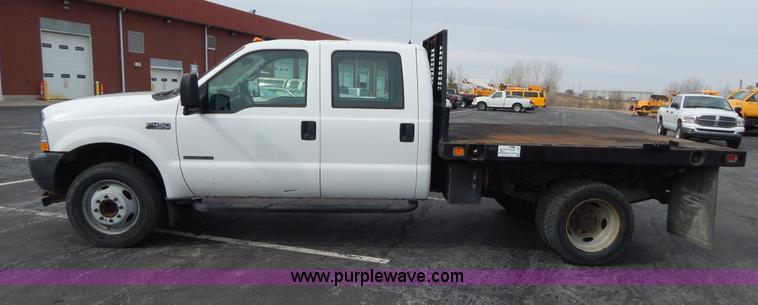 image for item I1082 2002 Ford F450 Super Duty Crew Cab flatbed truck