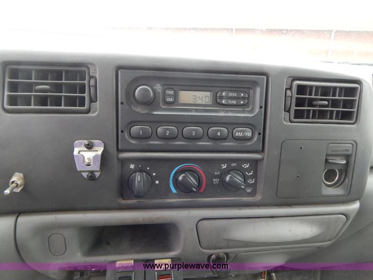 image for item I1082 2002 Ford F450 Super Duty Crew Cab flatbed truck