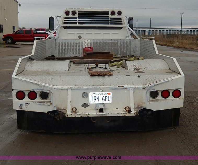 image for item H6186 1990 Ford F700 Crew Cab flatbed truck