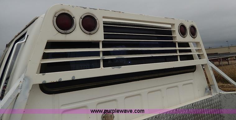 image for item H6186 1990 Ford F700 Crew Cab flatbed truck