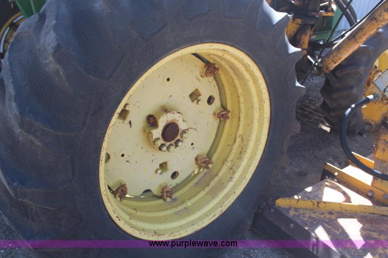 image for item H6218 1980 John Deere 2940 MFWD tractor with boom mower