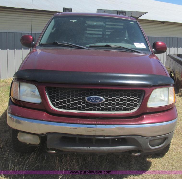 image for item I7124 2003 Ford F150 XLT flatbed pickup truck