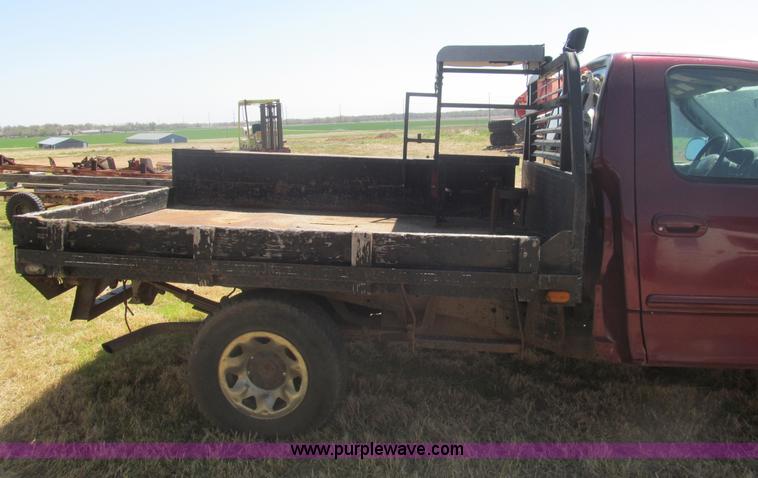 image for item I7124 2003 Ford F150 XLT flatbed pickup truck