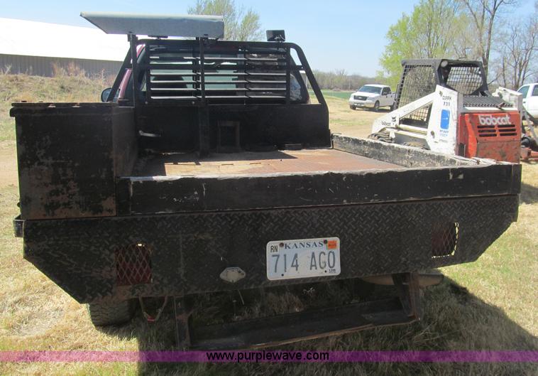 image for item I7124 2003 Ford F150 XLT flatbed pickup truck