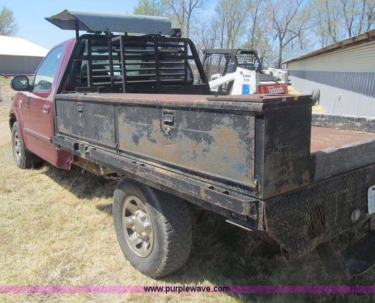 image for item I7124 2003 Ford F150 XLT flatbed pickup truck