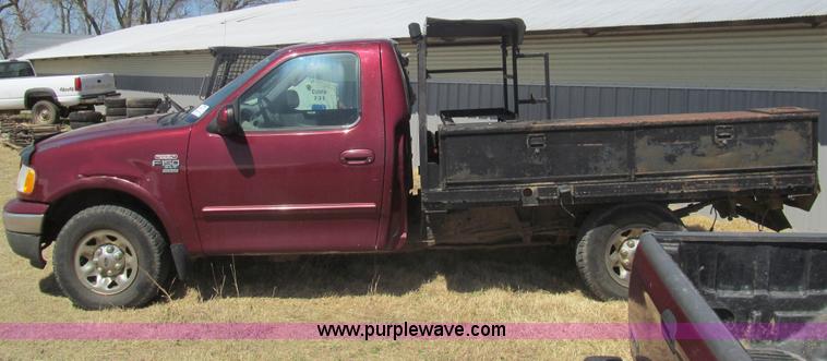 image for item I7124 2003 Ford F150 XLT flatbed pickup truck