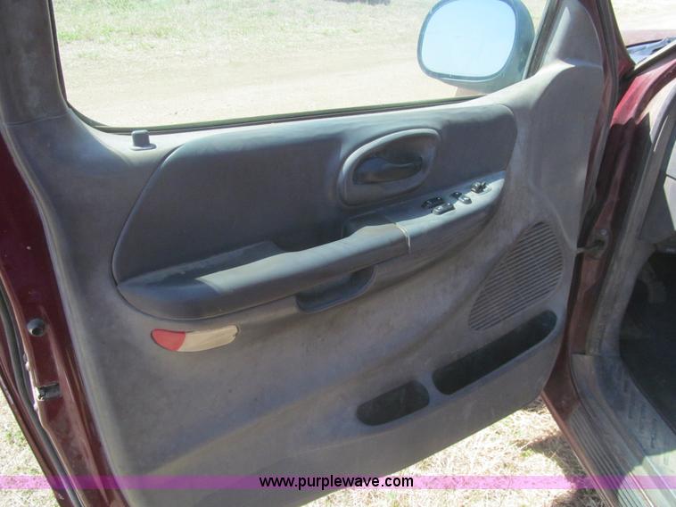 image for item I7124 2003 Ford F150 XLT flatbed pickup truck