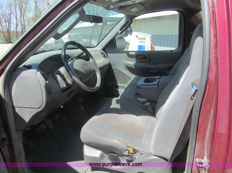 image for item I7124 2003 Ford F150 XLT flatbed pickup truck