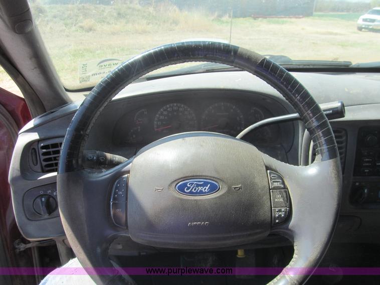 image for item I7124 2003 Ford F150 XLT flatbed pickup truck