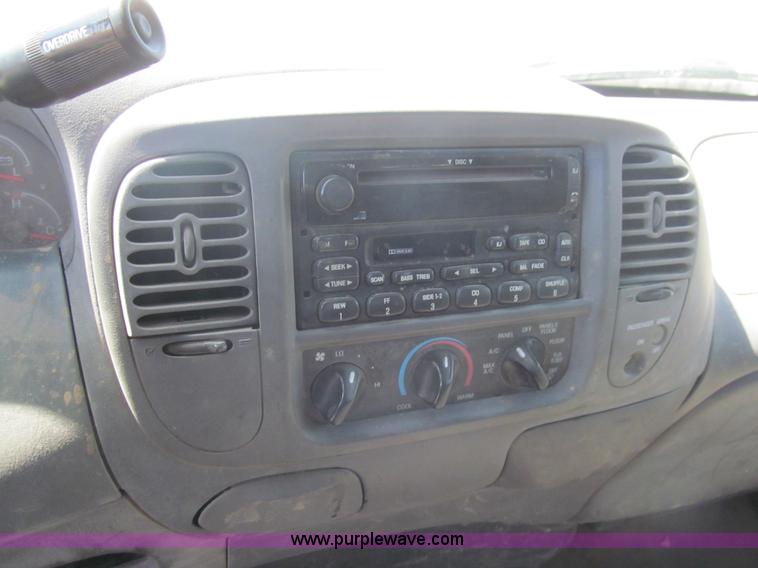 image for item I7124 2003 Ford F150 XLT flatbed pickup truck