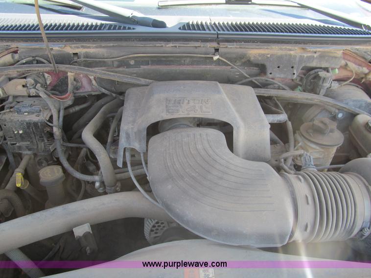 image for item I7124 2003 Ford F150 XLT flatbed pickup truck