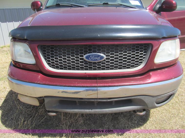 image for item I7124 2003 Ford F150 XLT flatbed pickup truck