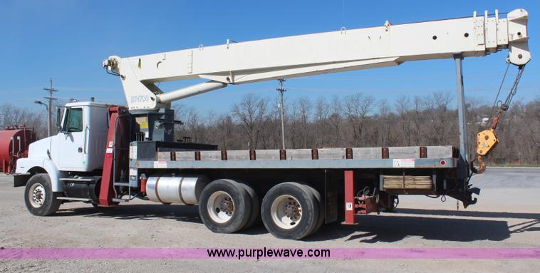 image for item H6004 2001 Volvo WG64 flatbed truck with Terex boom