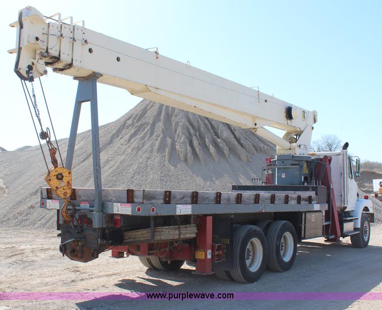 image for item H6004 2001 Volvo WG64 flatbed truck with Terex boom