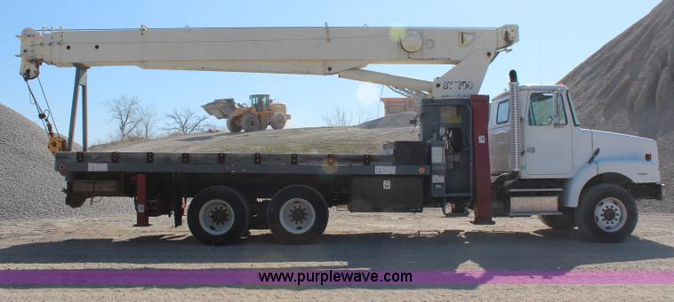 image for item H6004 2001 Volvo WG64 flatbed truck with Terex boom