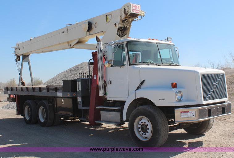 image for item H6004 2001 Volvo WG64 flatbed truck with Terex boom