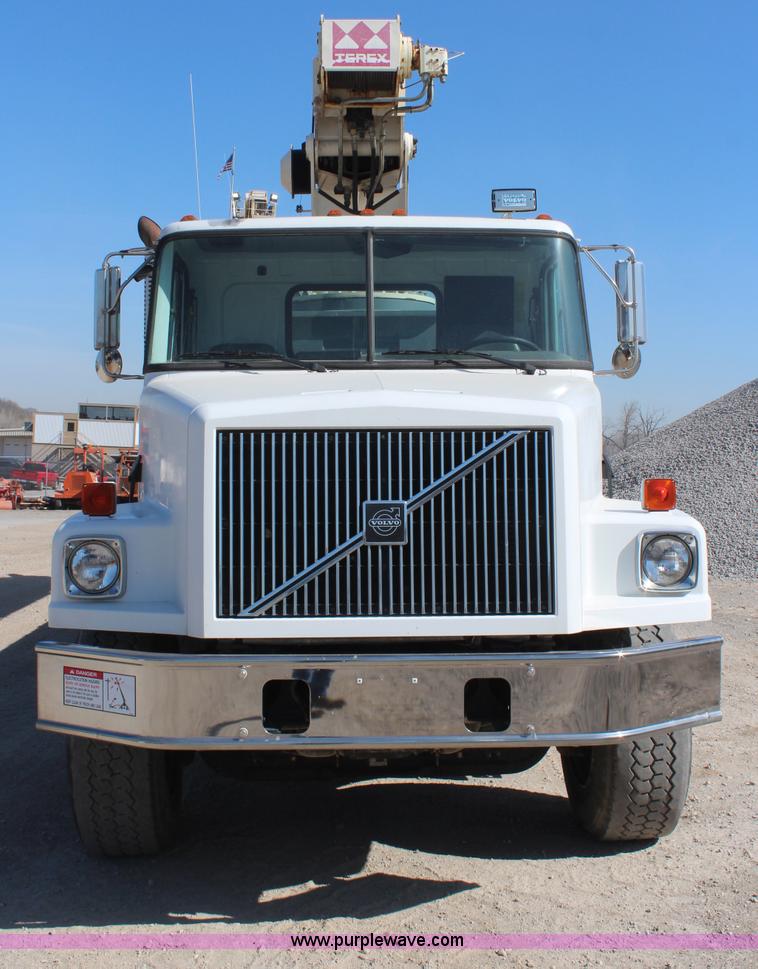 image for item H6004 2001 Volvo WG64 flatbed truck with Terex boom