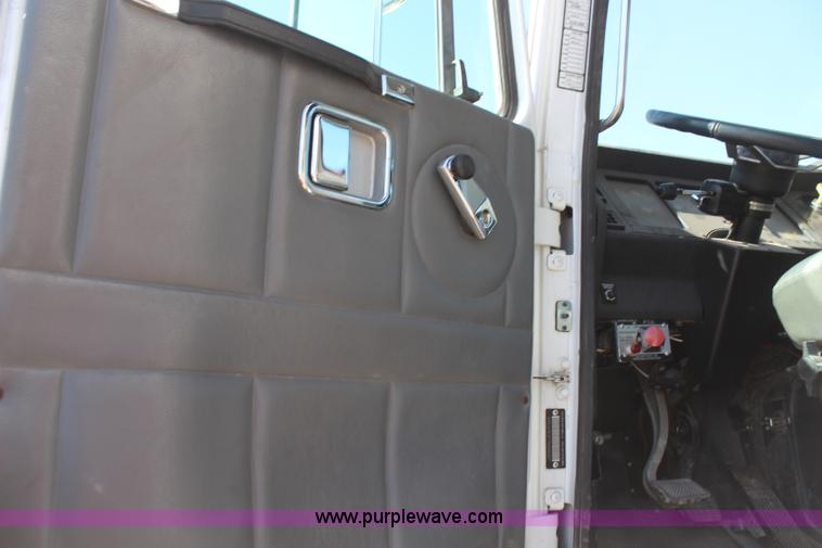 image for item H6004 2001 Volvo WG64 flatbed truck with Terex boom