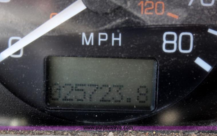 image for item H6004 2001 Volvo WG64 flatbed truck with Terex boom