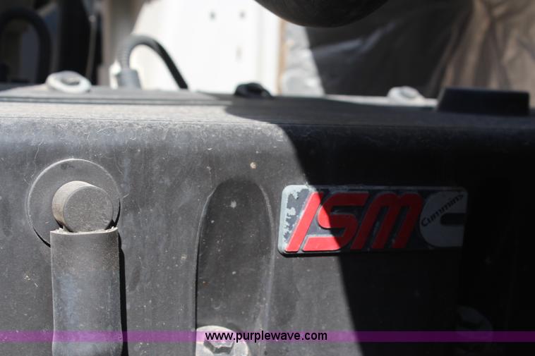 image for item H6004 2001 Volvo WG64 flatbed truck with Terex boom