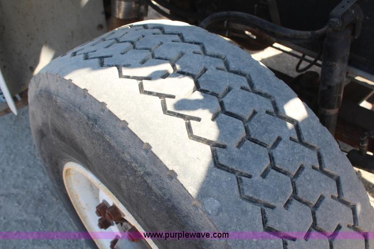 image for item H6004 2001 Volvo WG64 flatbed truck with Terex boom