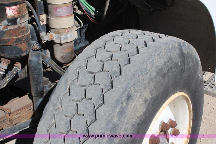 image for item H6004 2001 Volvo WG64 flatbed truck with Terex boom