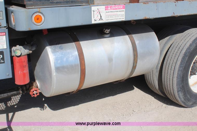 image for item H6004 2001 Volvo WG64 flatbed truck with Terex boom