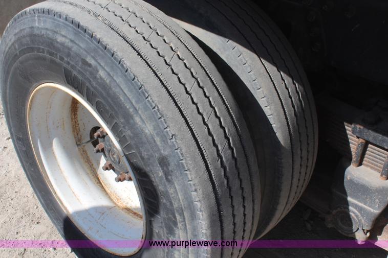 image for item H6004 2001 Volvo WG64 flatbed truck with Terex boom