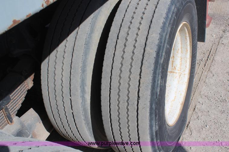 image for item H6004 2001 Volvo WG64 flatbed truck with Terex boom