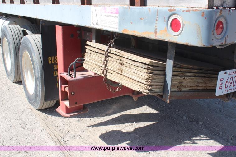 image for item H6004 2001 Volvo WG64 flatbed truck with Terex boom