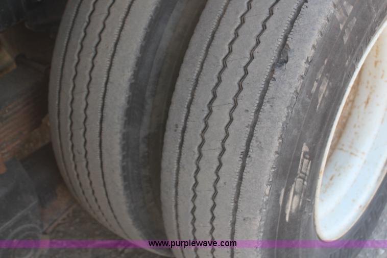 image for item H6004 2001 Volvo WG64 flatbed truck with Terex boom