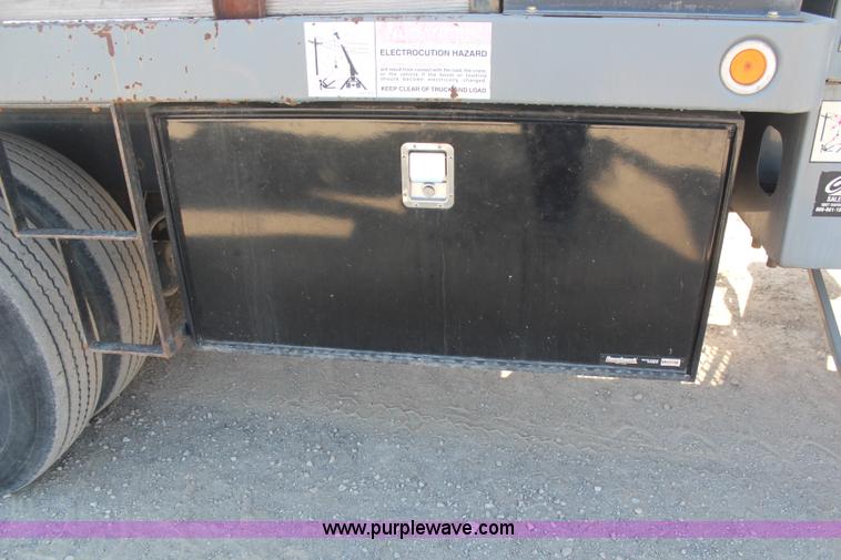 image for item H6004 2001 Volvo WG64 flatbed truck with Terex boom