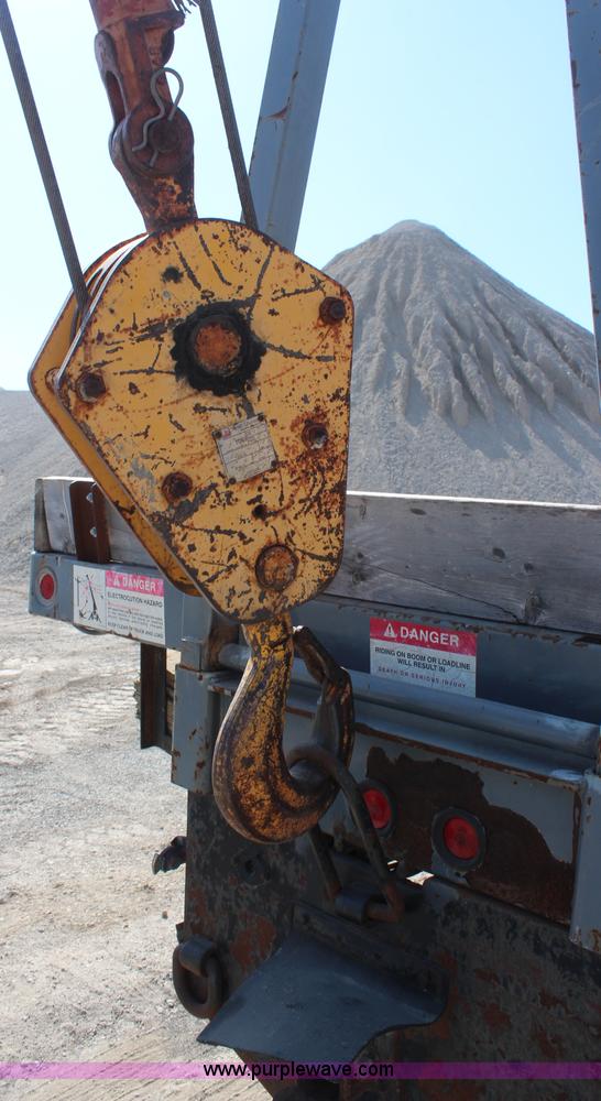 image for item H6004 2001 Volvo WG64 flatbed truck with Terex boom