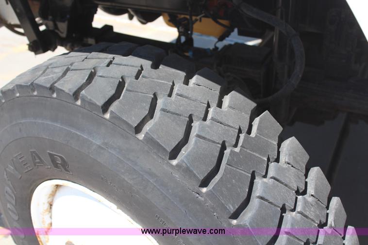 image for item H6088 2003 Freightliner FL80 flatbed truck with knuckle boom crane